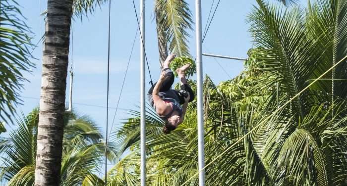 woman enjoying a trapeze lesson
