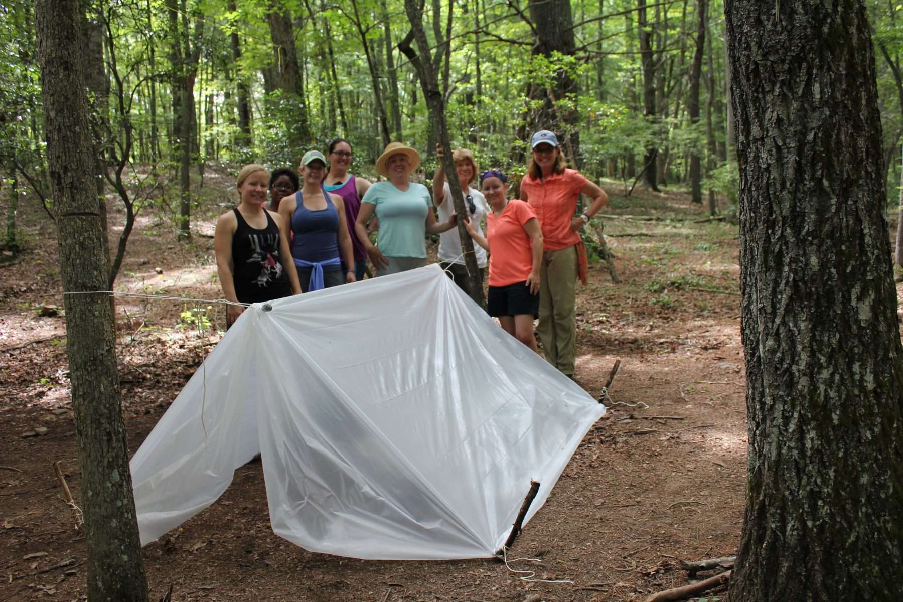 group of woman with survival shelter