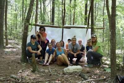 Group of women resting in the forest while on a hike in Virginia