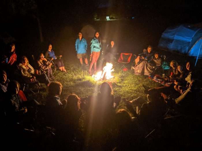 Big group of women sitting around the fire