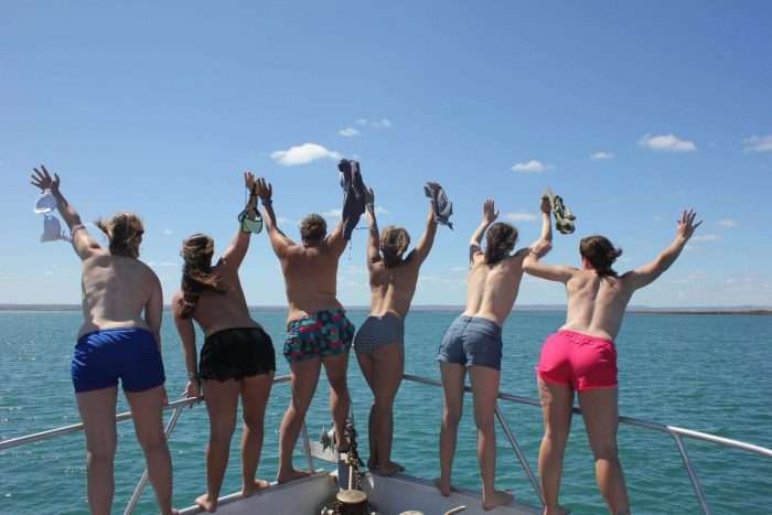 A group of women standing on the bow of a small cruise ship in Baja Mexico