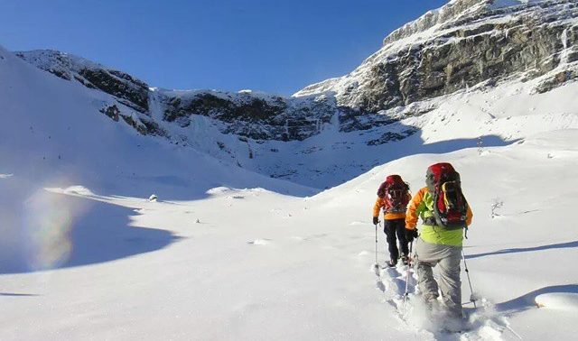 woman snowshoeing into elizabeth parker snow hut in the canadian rockies