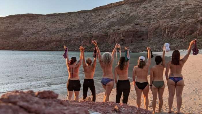 Women standing on beach in swimsuit bottoms during a vacation in Baja California, Mexico